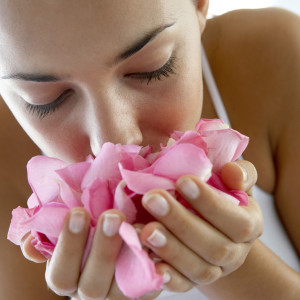 Woman smelling flower petals